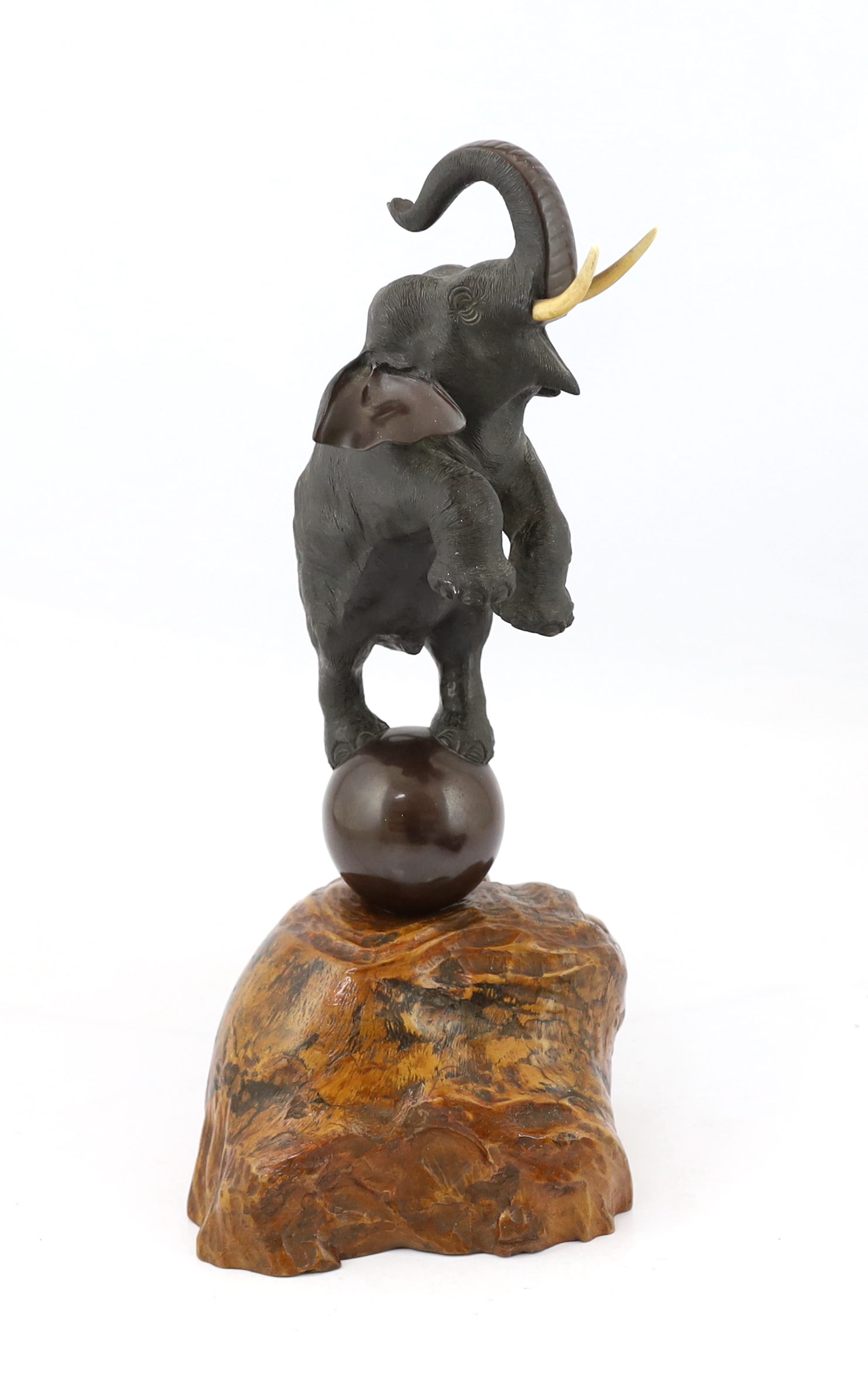 A Japanese bronze model of a rearing elephant standing on a ball, Meiji period